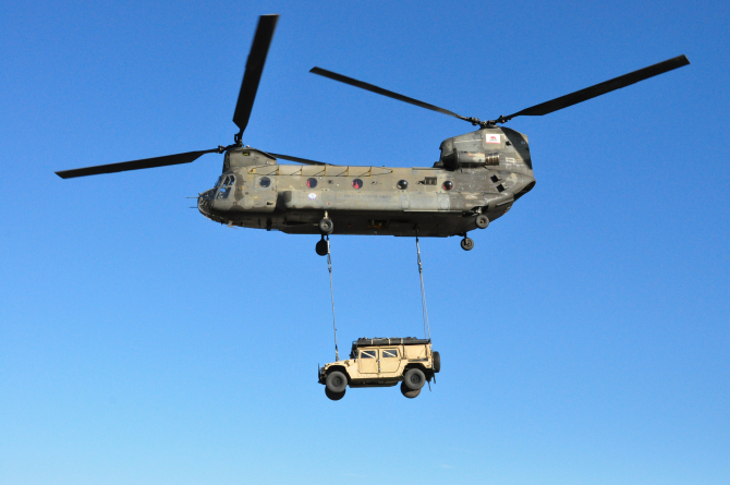 Un elicopter CH-47 Chinook, transportând un Hummer Travis. Sursă foto: U.S. Air Force 